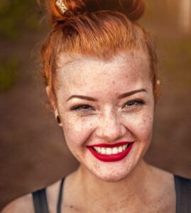 A young lady smiling with happy, healthy gums free of inflammation.