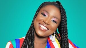 A young woman in a colorful dress, happy with results from cosmetic dentistry in Oceanside.