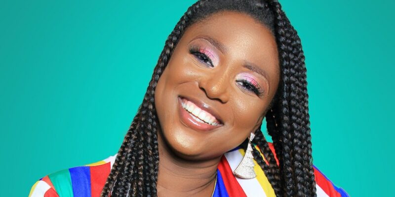 A young woman in a colorful dress, happy with results from cosmetic dentistry in Oceanside.