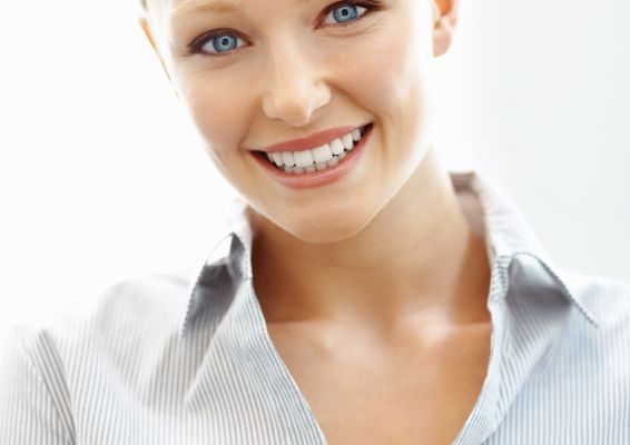 A blonde young woman smiling after professional teeth whitening in Oceanside.